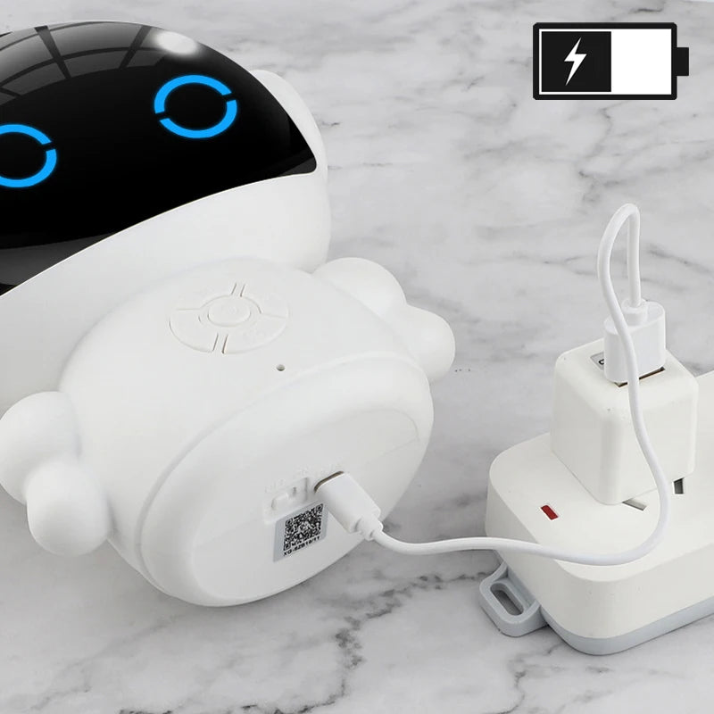 White Smart AI Robot with blue lights on a marble surface, plugged into an outlet.