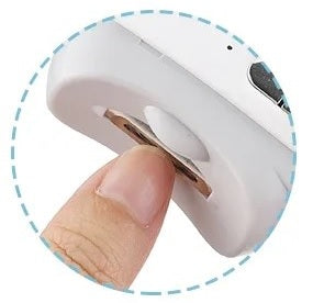 User places nail into Electric Nail Clipper slot as precision blade safely trims and shapes without pain or pressure.